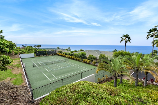 view of sport court featuring a water view and fence