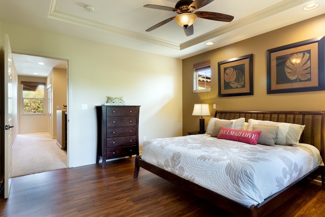 bedroom featuring dark wood-style floors, recessed lighting, and a raised ceiling