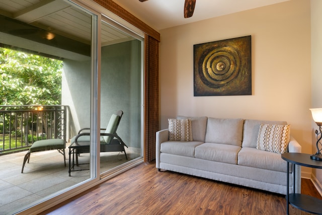 living area with dark wood-type flooring, expansive windows, and ceiling fan