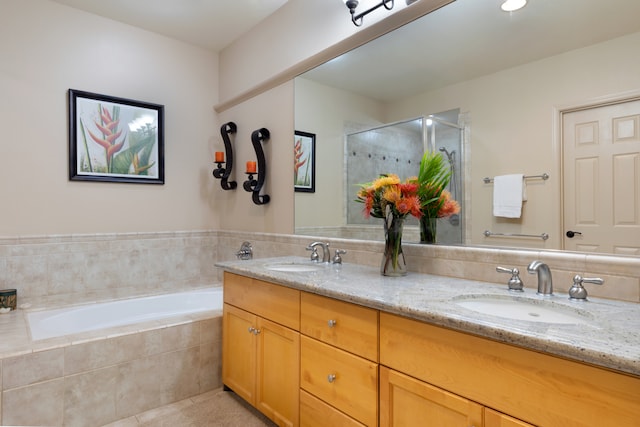 full bath featuring double vanity, a stall shower, a sink, and a bath