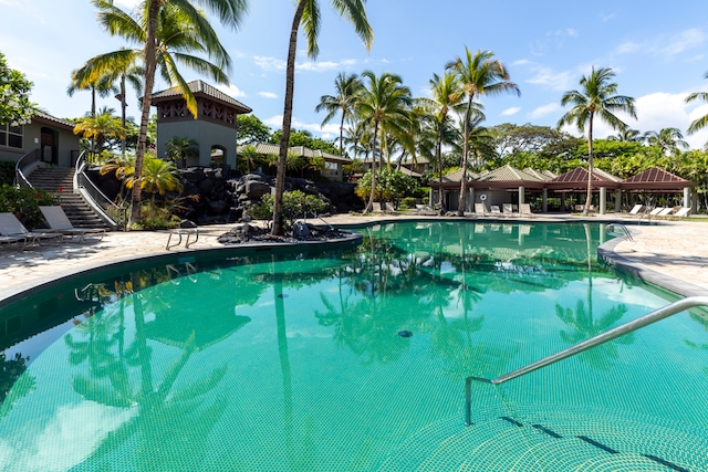 pool featuring stairs and a gazebo