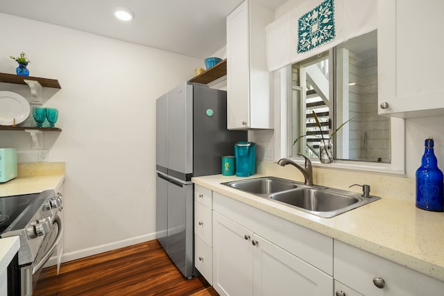 kitchen featuring dark wood-style flooring, open shelves, stainless steel appliances, white cabinets, and a sink