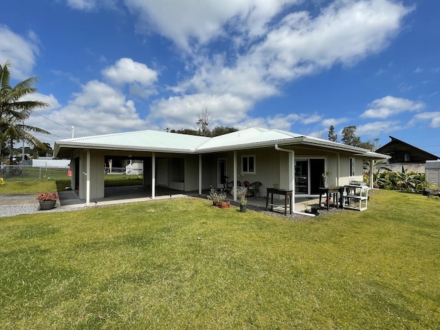 rear view of house with a patio area and a yard