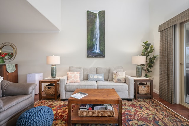 living room with crown molding and dark wood finished floors