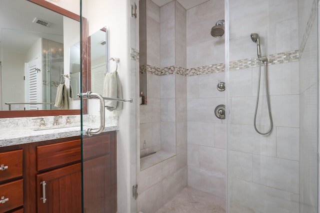 bathroom with a stall shower and vanity