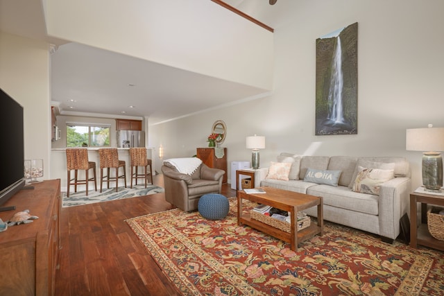 living room featuring ornamental molding and wood finished floors