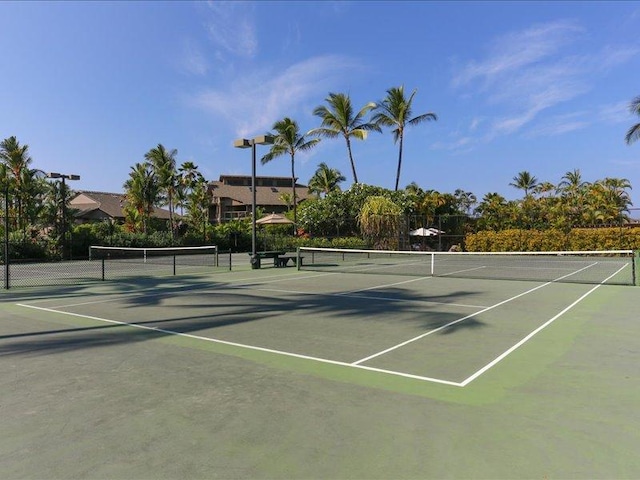 view of tennis court with fence