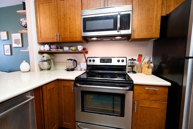 kitchen featuring brown cabinets, appliances with stainless steel finishes, open shelves, and light countertops