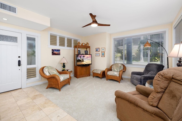 sitting room featuring ceiling fan and light carpet