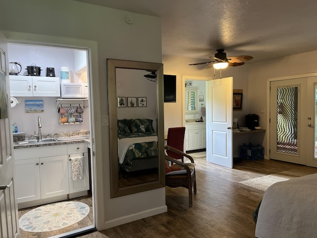 interior space featuring sink, french doors, dark hardwood / wood-style floors, and ceiling fan