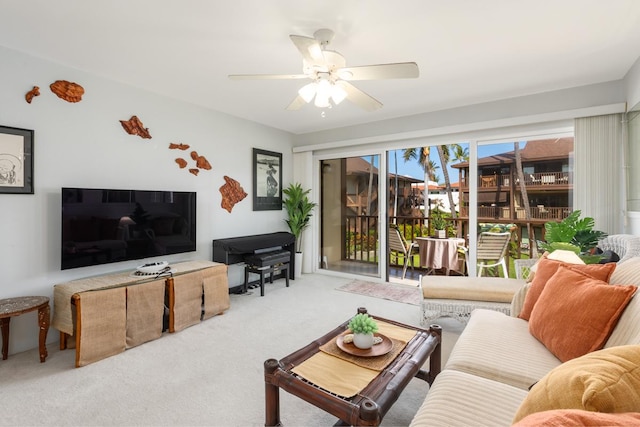 living area with carpet floors and a ceiling fan