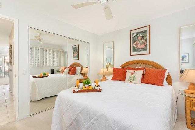 bedroom with ceiling fan, a closet, and light carpet