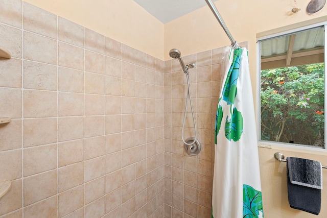 bathroom with tiled shower