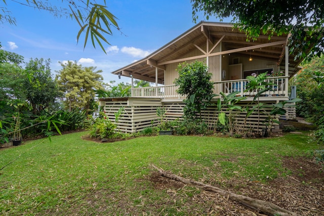 back of house with a lawn