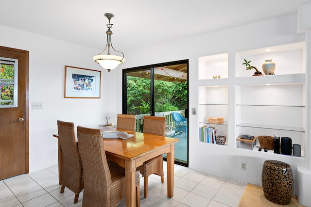 dining space featuring built in features and light tile patterned flooring