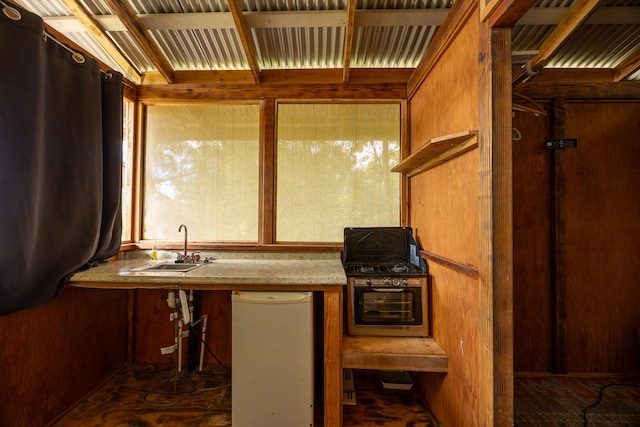 kitchen with brown cabinetry and a sink