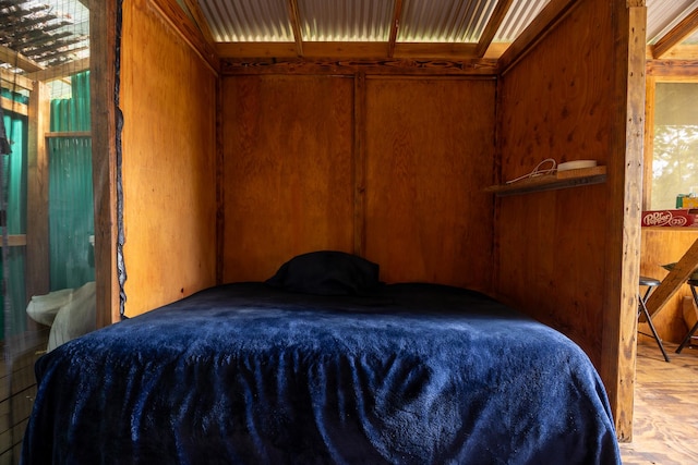 bedroom featuring wood walls