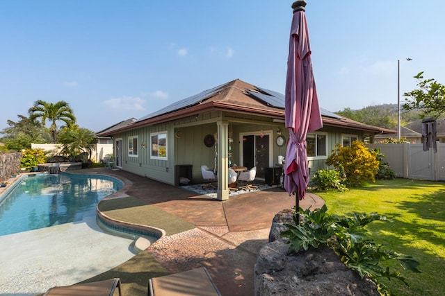 rear view of property with a fenced backyard, a yard, a fenced in pool, board and batten siding, and a patio area