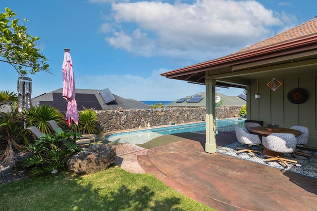 view of swimming pool with a fenced in pool and a patio