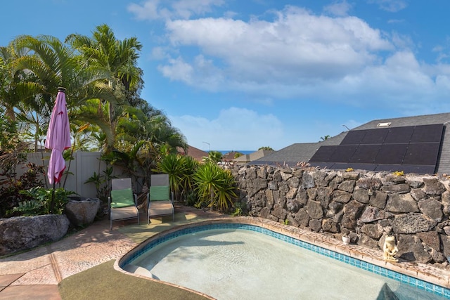 view of pool featuring fence