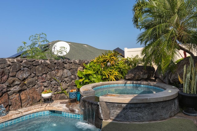 view of pool featuring an in ground hot tub