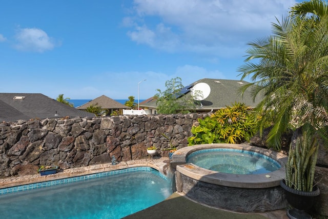 view of swimming pool with an in ground hot tub and a fenced in pool