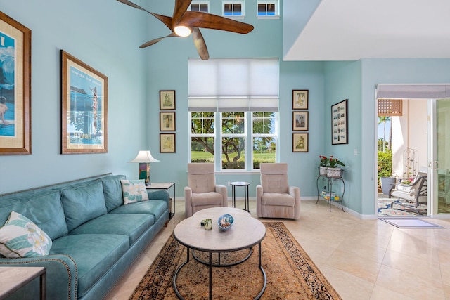 living room with baseboards, a ceiling fan, and light tile patterned flooring