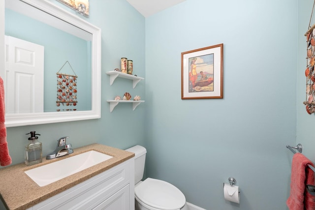 bathroom with toilet and vanity