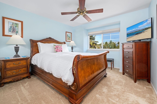 bedroom featuring light carpet, ceiling fan, and baseboards