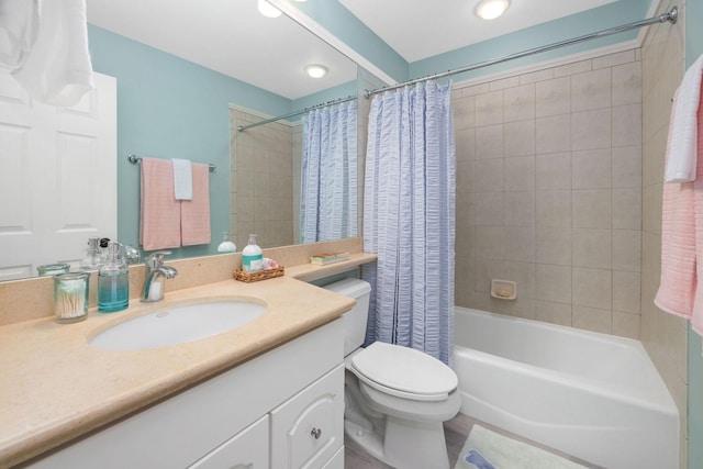 bathroom featuring toilet, shower / bath combo with shower curtain, and vanity