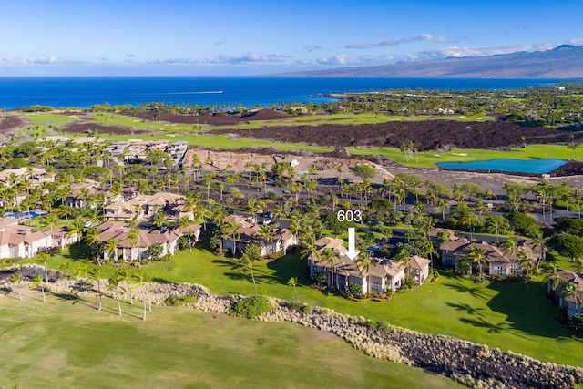 aerial view with golf course view, a water view, and a residential view