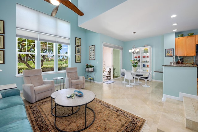 living area with a chandelier, recessed lighting, and baseboards