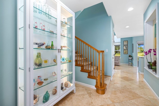 stairway with recessed lighting and baseboards