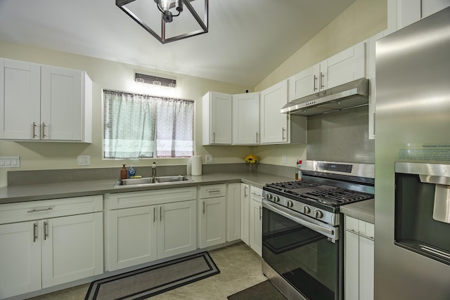 kitchen featuring under cabinet range hood, a sink, white cabinetry, appliances with stainless steel finishes, and vaulted ceiling