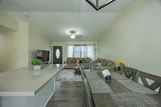 unfurnished dining area with lofted ceiling and dark wood-style floors