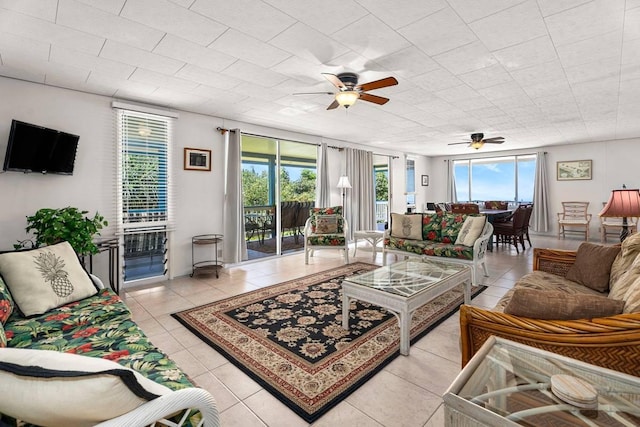 living room featuring light tile patterned floors and a ceiling fan