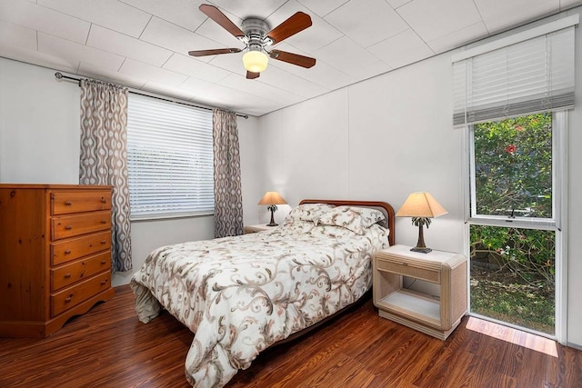 bedroom with dark wood-type flooring and a ceiling fan