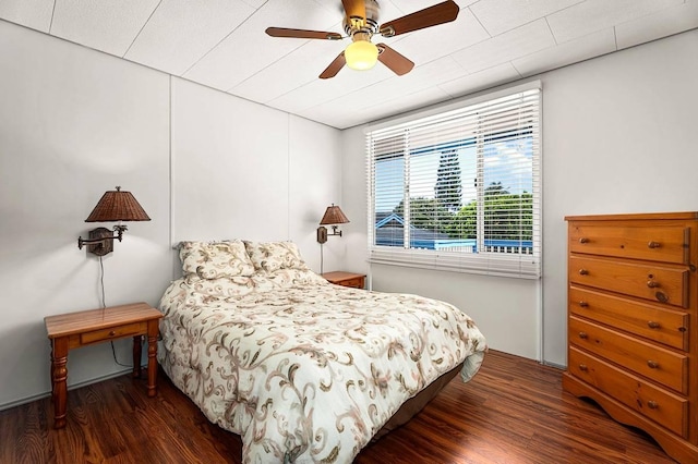 bedroom with ceiling fan and dark wood-style flooring