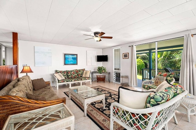 living area with light tile patterned floors and ceiling fan