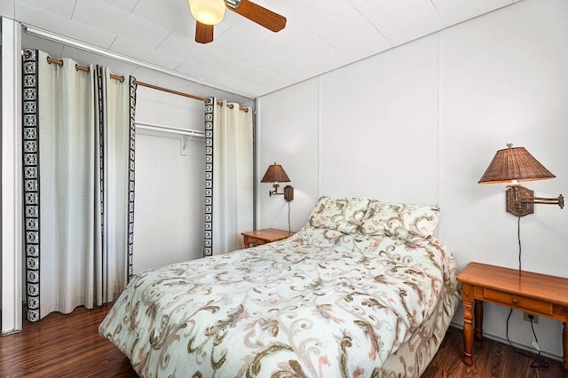 bedroom with ceiling fan and dark wood-type flooring