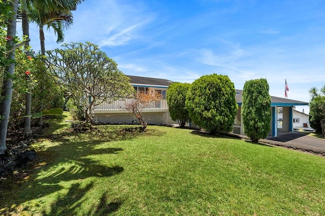 view of yard with aphalt driveway