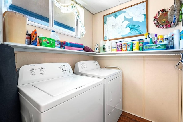 laundry room with laundry area, washer and clothes dryer, and dark wood-style flooring