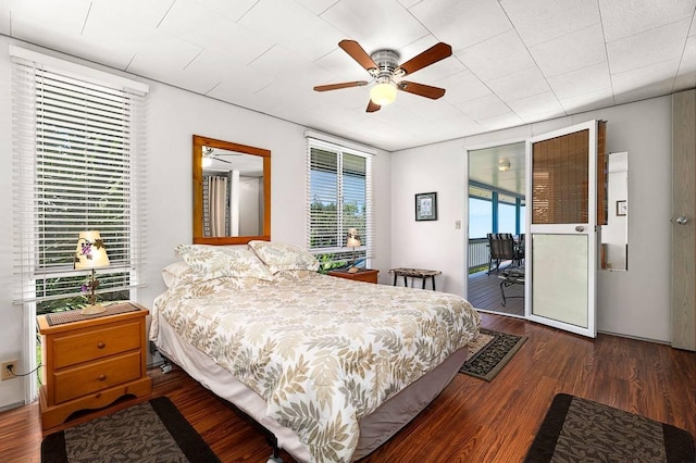 bedroom with a ceiling fan, access to outside, and dark wood-style flooring