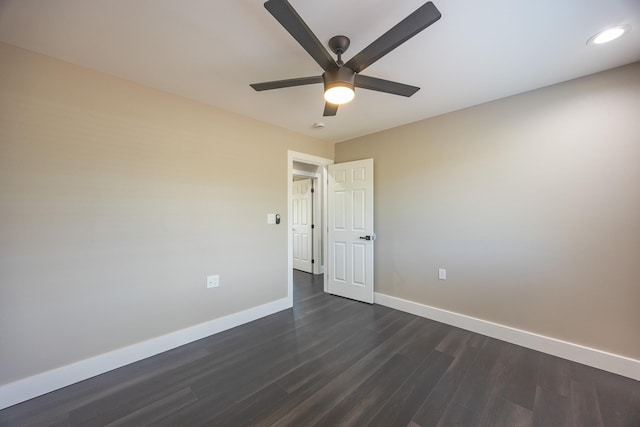 empty room featuring dark wood-type flooring, recessed lighting, ceiling fan, and baseboards