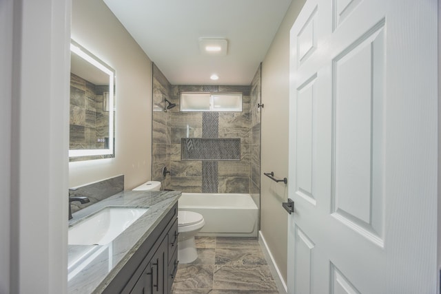 bathroom with baseboards, vanity, toilet, and bathing tub / shower combination