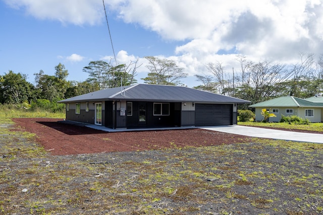 ranch-style house featuring a garage and driveway