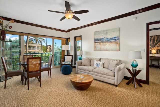 living area with a ceiling fan, carpet, baseboards, and crown molding