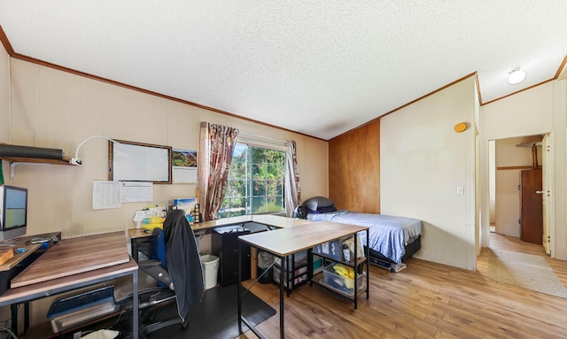 office area with lofted ceiling, a textured ceiling, wood finished floors, and crown molding