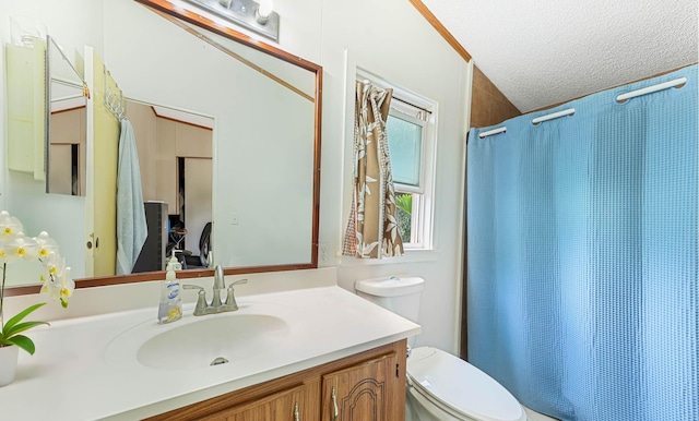 bathroom with a textured ceiling, a shower with shower curtain, vanity, and toilet