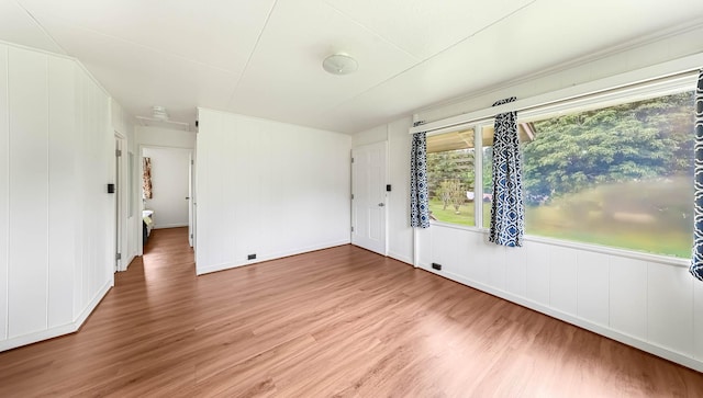 spare room featuring wood finished floors